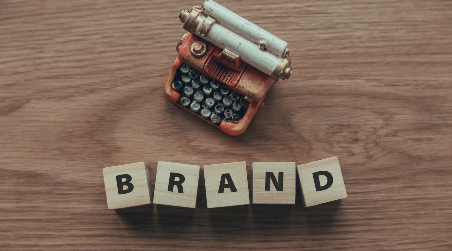 top-view-of-typewriter-and-wooden-cube-with-text-brand-on-wooden-background-.jpg top-view-of-typewriter-and-wooden-cube-with-text-brand-on-wooden-background-.jpg